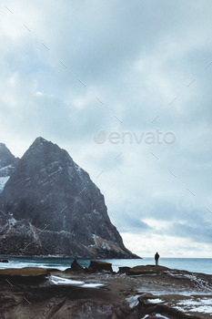 Fjord beach with man silhouetted agains the sky and sea