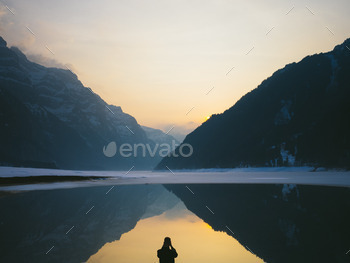 Man takes a picture of a beautiful alpine view