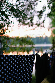 Clothes hanging on drying line near a lake