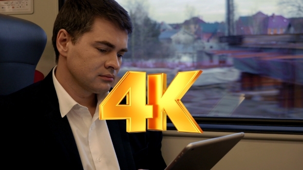 Young Businessman Working With Pad In The Train Young Businessman Working With Pad In The Train