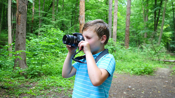 Boy In Wilderness Area Taking Picture Boy In Wilderness Area Taking Picture