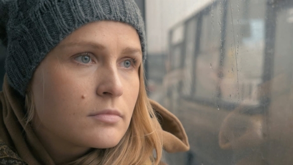 Woman Staring Through The Wet Bus Window Woman Staring Through The Wet Bus Window