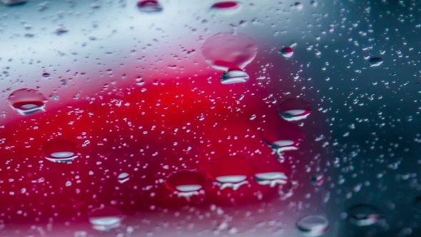Raindrops Running On Car Window During Rain 