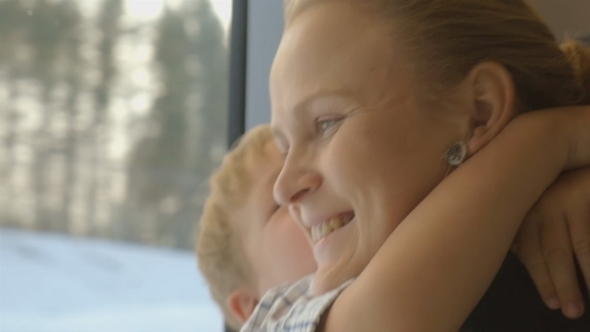 Little Child Embracing Mother In Train Little Child Embracing Mother In Train