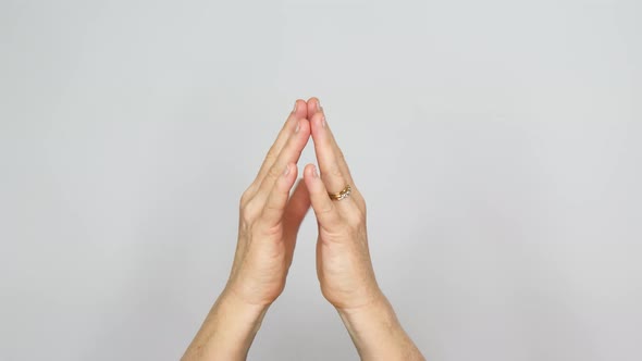 Contemplative gesture of finger tips tapping their tips rhythmically together. alt