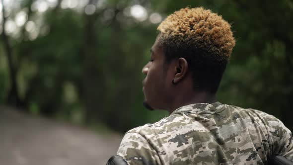 Closeup African American Young Man in Wheelchair Turning Looking at Camera Smiling alt