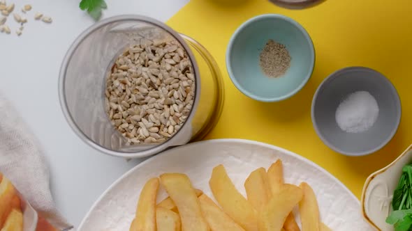 Vertical Flat Lay Video Chef Adds Parsley and Sunflower Seeds to the Blender Bowl