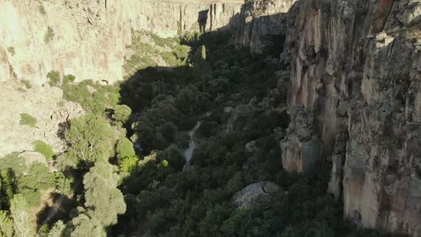 Aerial Deep Long Rift Canyon with Cleft Steep Rock Walls and High Cliff Gorge alt