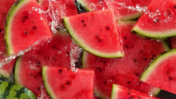 Super Slow Motion Shot of Splashing Water on Fresh Watermelon Slices at 1000Fps alt