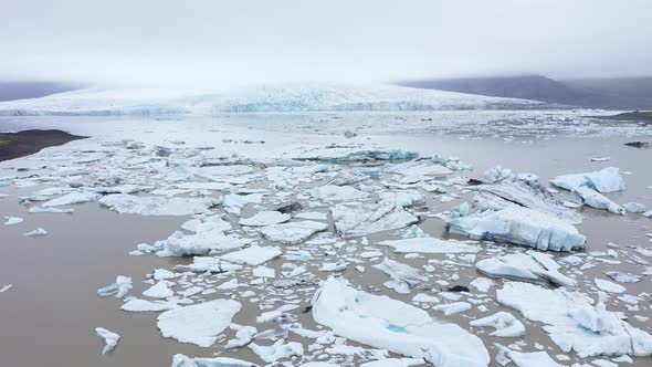 Floating Icebergs in Fjallsarlon Glacial Lagoon, Iceland. Aerial View. Climate Change alt