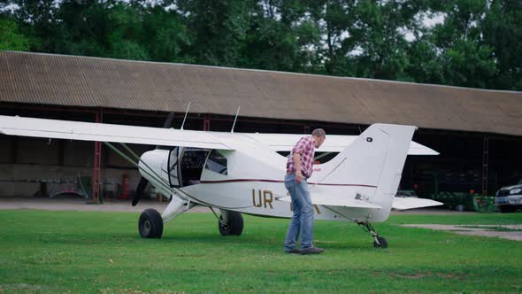 Plane Engineer Checking Airplane on Airdrome alt