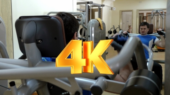 Man Having Workout On Modern Exercise Machine Man Having Workout On Modern Exercise Machine