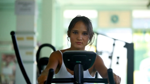 Beautiful Woman At The Gym On Bike