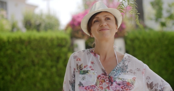 Smiling Thoughtful Woman Wearing Summer Fashion alt