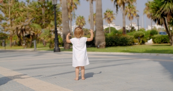 Small Girl Chasing Air Bubbles Small Girl Chasing Air Bubbles