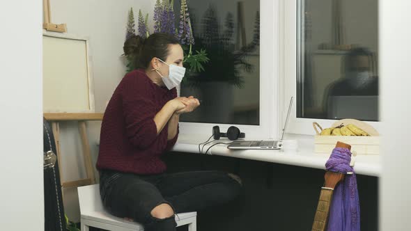Excited young woman in protective medical face mask received news about end of quarantine. alt