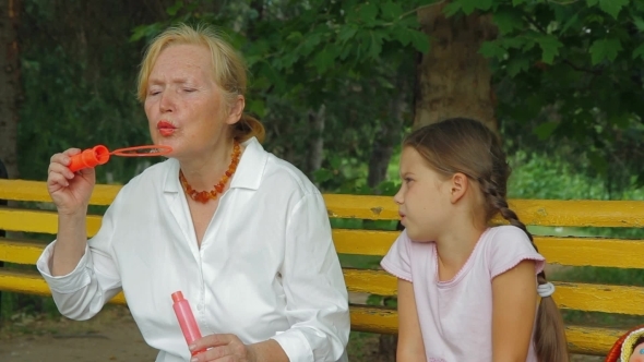 Grandmother And Granddaughter On A Bench