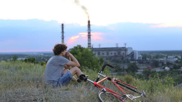 Cyclist on the Background of the Plant alt