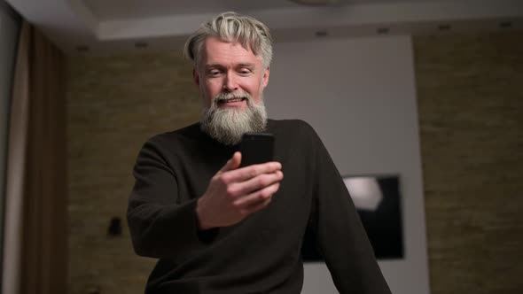 An adult man speaks via video link with relatives alt