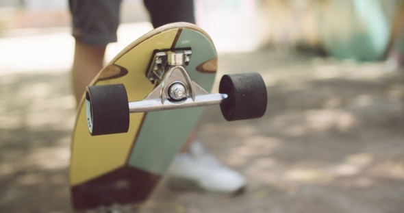 Man Tipping Up a Skateboard Man Tipping Up a Skateboard