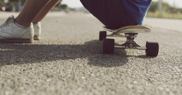 Boy Sitting Resting On His Skateboard Boy Sitting Resting On His Skateboard