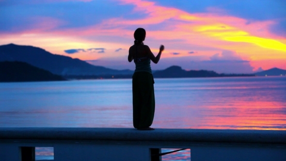 Beautiful Sunset And Young Woman Rising Her Hands