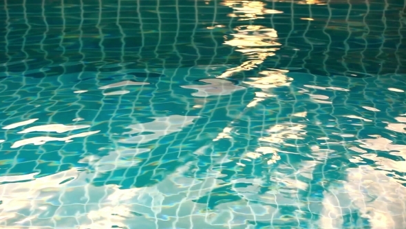 Shining Blue Water Ripple In Pool At Sunset Time. 