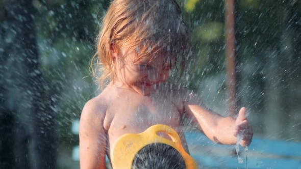 Girl Pours Water From a Hose Girl Pours Water From a Hose