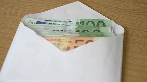 Hand Moves Envelope With Euro Money On The Table