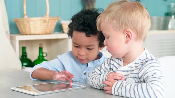 Diverse Little Boys Using Digital Tablet