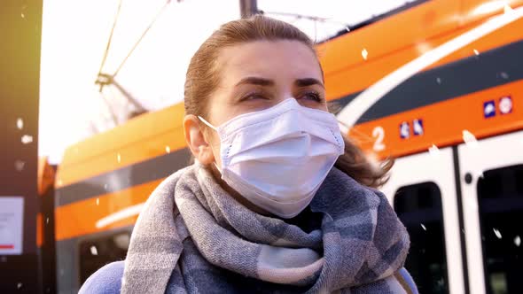 Woman in Face Mask at Railway Station in Winter alt