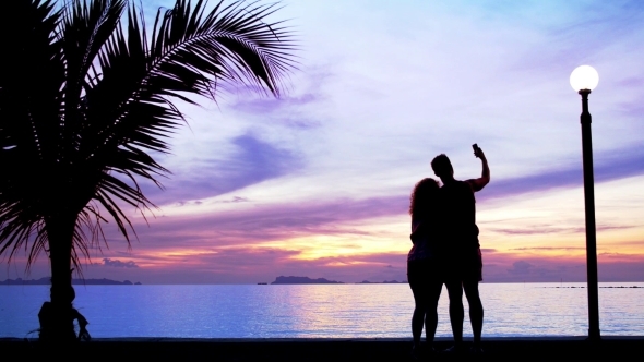 Silhouette Couple Make Photo Against Sunset Silhouette Couple Make Photo Against Sunset