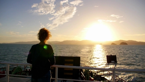 Young Curly Woman Enjoying Beautiful Sunset From