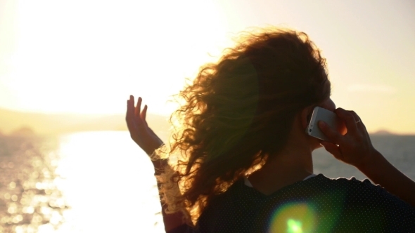 Young Woman With Curly Hair Talking By Smart Phone Young Woman With Curly Hair Talking By Smart Phone