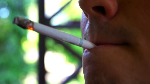 Man Smokes a Cigarette