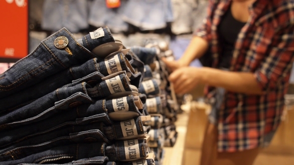 Woman Shopping for Jeans Shorts in Clothing Store Woman Shopping for Jeans Shorts in Clothing Store
