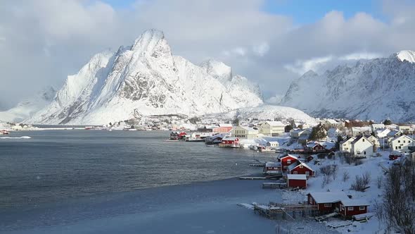 Norwegian fishing town on the background of winter mountains
