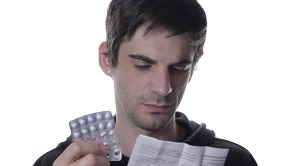 A Portrait of a Young Man Reads the Instructions To Cold Pills, Isolate