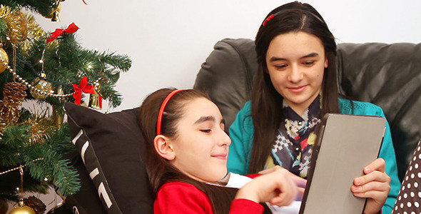 Girls with Digital Tablet near Christmas Tree 2 Girls with Digital Tablet near Christmas Tree 2