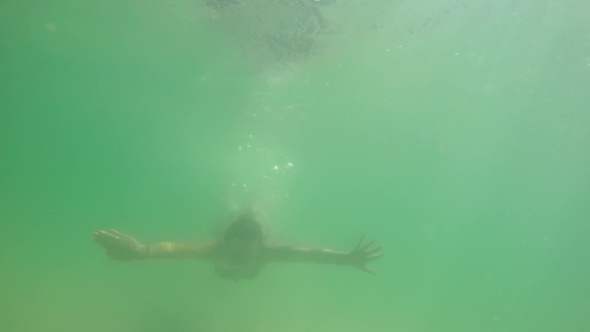 Woman Swimming Underwater In The Sea Woman Swimming Underwater In The Sea