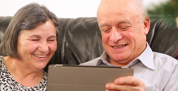Senior Couple Using Digital Tablet at Christmas 2 Senior Couple Using Digital Tablet at Christmas 2