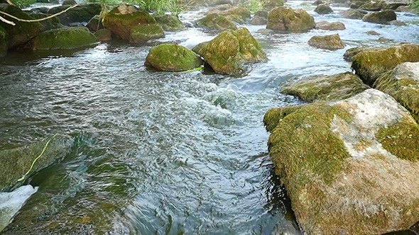 Fast Flowing River With Stones In Water Fast Flowing River With Stones In Water