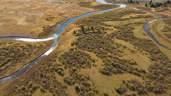 Flying over the Madison River as it winds through the landscape alt