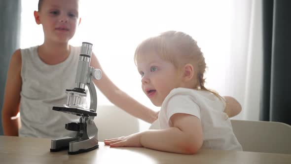 Child Baby Caucasian Little Boy Scientist Biologist Researcher Working with Microscope and Show It