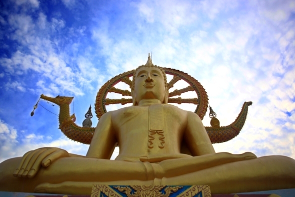 Golden Buddha Statue Against Blue Sky With Moving
