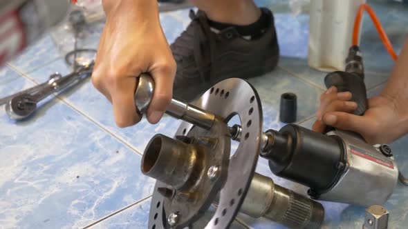 Close-up Footage of The Technician Working On Motorcycle Brake Caliper Cleaning Process alt