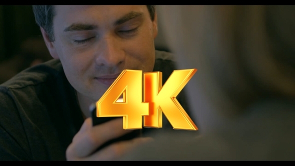 Young Man With Pleased Smile Texting On Cell Phone alt