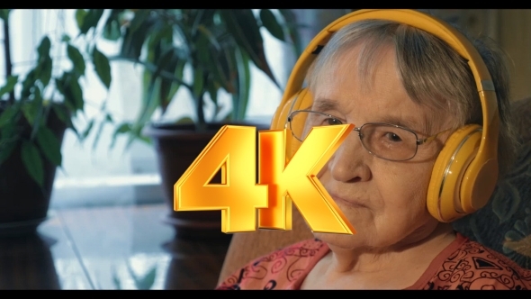 Senior Woman Listening To The Music In Headphones Senior Woman Listening To The Music In Headphones