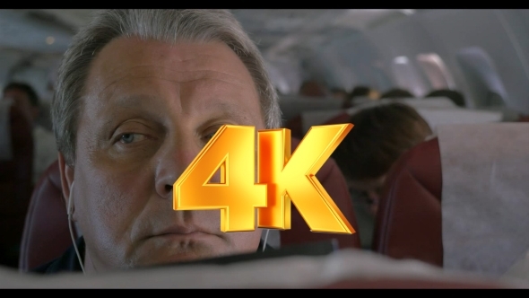 Sleepy Man Listening To Music In Airplane alt