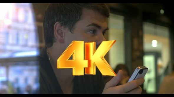 He Has a Vivid Talk With Mobile In Hands alt